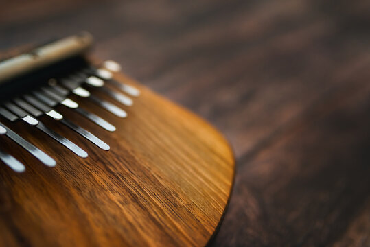 Kalimba - a musical instrument with a wooden soundboard and metal keys.  In the classification of musical instruments the kalimba is in the category of lamellophones or plucked idiophones.