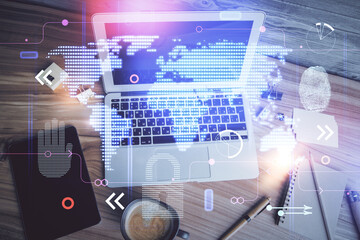 Double exposure of map hologram drawing over study table background with computer. Concept of international network. Top view.