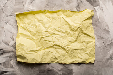 crumpled paper on concrete