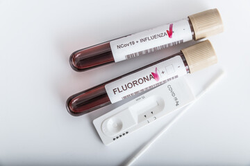 Obraz premium Blood samples of new variant OMICRON plus flu FLUORONE, covid19, coronavirus. Selective approach to the sample tube.