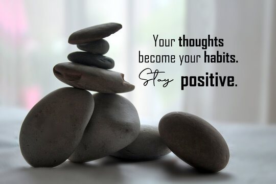 Life balance inspirational quote - Your thoughts become your habits. Stay positive. With zen stones on light white background. Attitude, life positive thinking and positivity concept.