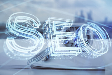 Multi exposure of SEO drawings and desk with open notebook background. Concept of Search...