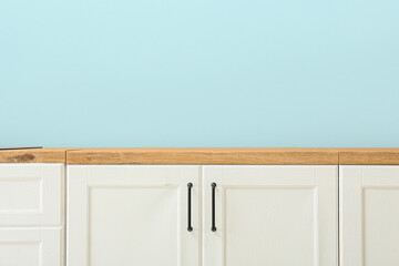 white wooden counters near blue wall