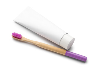 Purple bamboo tooth brush and paste on white background