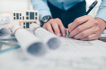 Architect engineer use pen drawing design working on bueprint. House planning design and...