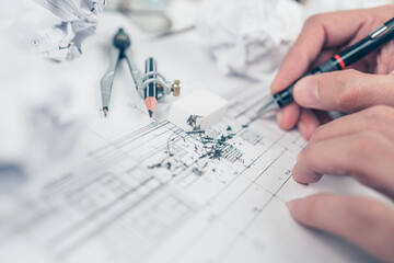 eraser crumbs and compass on drawing design working on bueprint. House planning design and construction concept.