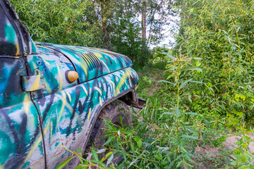 Old SUV stuck in the forest