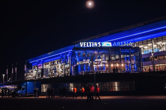 Gelsenkirchen, North Rhine-Westphalia, Germany - October 2021: Night view on the front facade of Veltins Arena (also known as Arena AufSchalke), home stadium for Bundesliga team FC Schalke 04