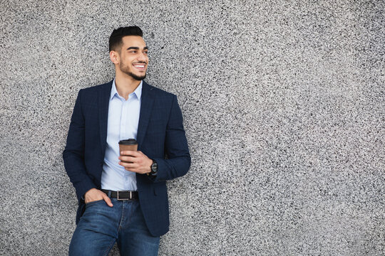 Handsome arab guy businessman with coffee to go outdoors