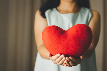 Close up of woman holding a heart pillow model for Valentines day, Mothers day and Breast Cancer...