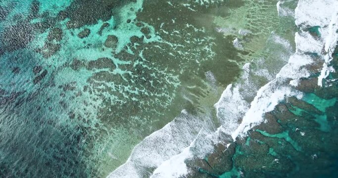 Aerial top view of coral reef and ocean waves in Irabu Island Miyako Okinawa Japan turquoise water texture