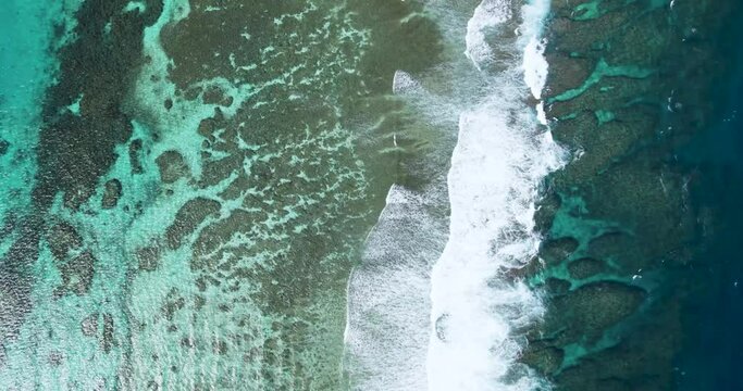 Aerial drone top view of coral reef and turquoise ocean waves in Miyako Island Okinawa Japan