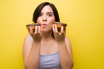 Surprised woman biting a donut