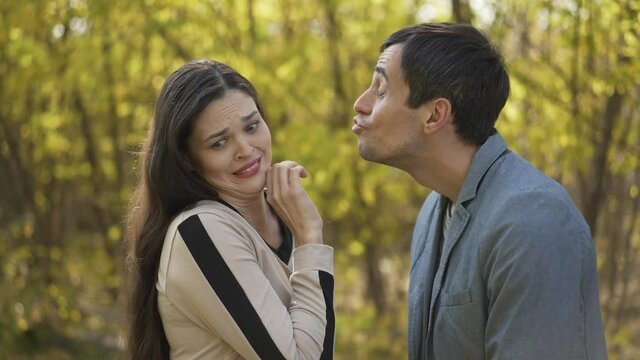 Funny man trying to kiss a woman