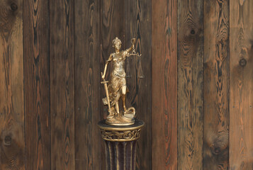 golden Themis goddess of justice on a stand