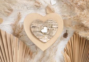 Heart shaped Valentines present near hearts, dried palm leaves and pampass grass