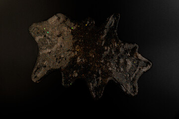 Coral transparent slime with bubbles inside on black background. Kids toy slime.