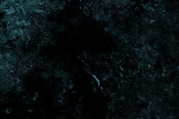 Close up view of a dark blue aged stone surface for texture background