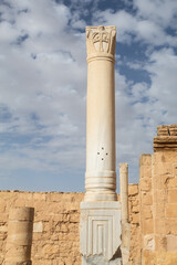 Marble pillar with engraving of a cross on it in an ancient Byzantine church in the desert with...