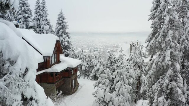 Ukraine, Skhidnytsia, Lviv region, forest house in the snowy Carpathian forest with a view of the city, drone, winter, Carpathians, mountains, snow