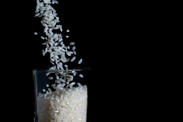 white rice poured into a glass, splash