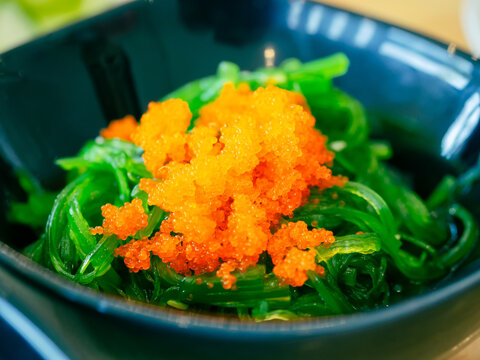 Seaweed salad topped with shrimp roe or flying fish roe (tobiko). Japanese food.