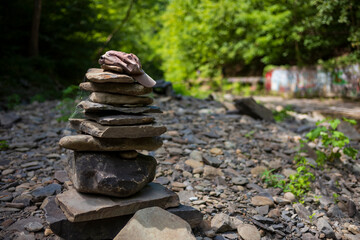 A stack of stones with a baseball cap