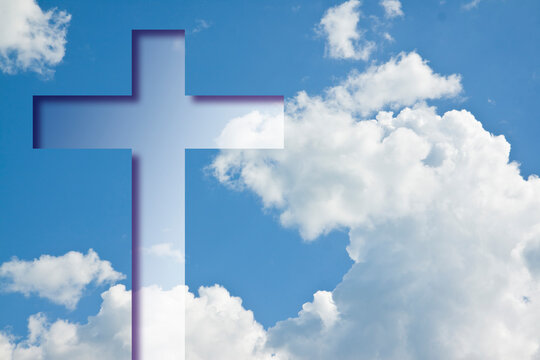 Christian cross symbol against a cloudy sky - concept image with copy space