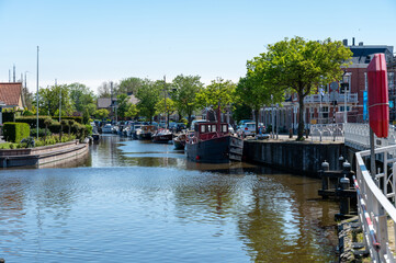 Walking on old streets of Harlingen fisherman town on Wadden sea, Friesland, Netherlands