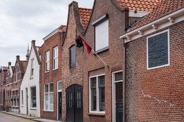 Walking in old Dutch town Zierikzee with old small houses and streets