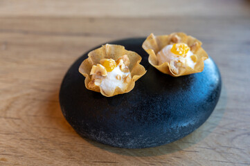 Tasty appetizer served on black stone in modern restaurant