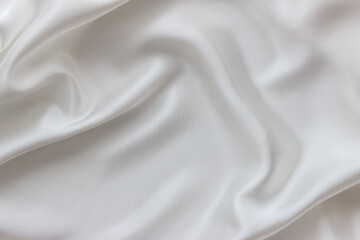 Fototapeta na wymiar White silk fabric background. Abstract texture for design. Flowing satin waves.