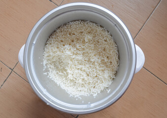 Top view of cooked rice in electric rice cooker.