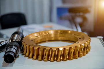 Gold-colored metal teeth of a round gear