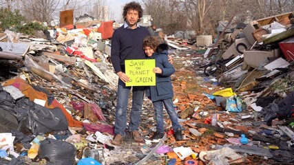 Father 40 years old and son child 7 ecologist holding a sign with the words save the planet go...