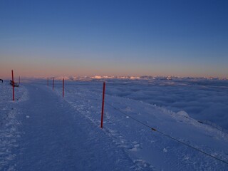 Hiking path at mountain station of Hoher Kasten cable car with spectacular view of Austrian Alps in winter. Alpstein, Appenzell, Switzerland.