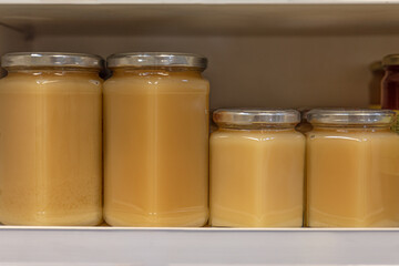 Jars of different varieties of honey stored on a shelf