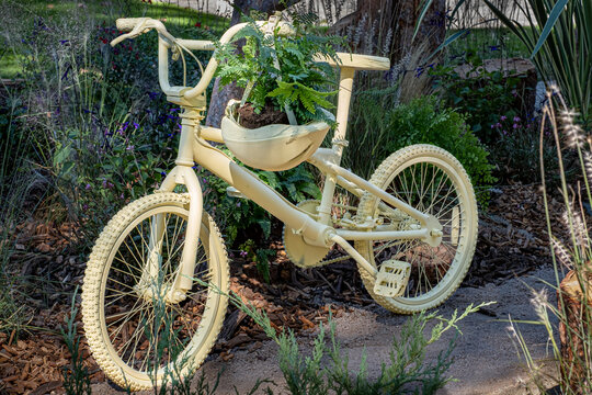 Yellow painted bicycle with helmet