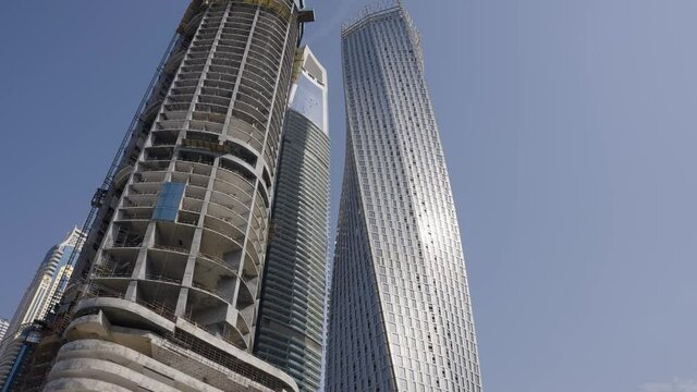Dubai Building Under Construction at Marina Entrance Close Up Pan Up