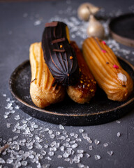 still life with eclairs on a dark background