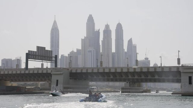 Dubai Speedboat Approaching Bridge with Skyline in the Background