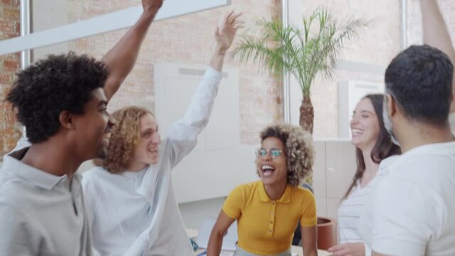 Group of young multiethnic entrepreneurs celebrating business success