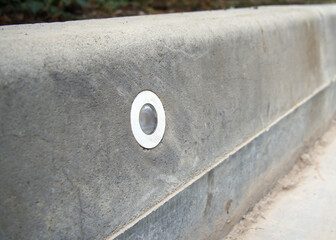 Road curb with integrated illumination lamp