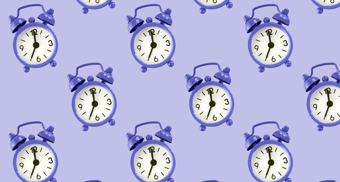 Purple alarm clocks pattern on purple background, very peri color of 2022