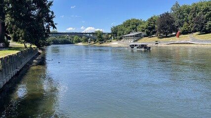 The Waikato River in Hamilton New Zealand looking towards Victoria Bridge. A river boat in picture. 