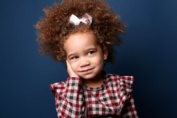 Beautiful toddler in front of a colored background