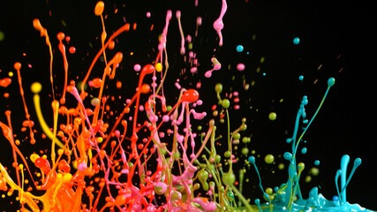 Freeze motion shot of color liquid explosion isolated on black background.