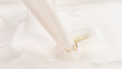 Obraz na płótnie Canvas Pouring milk splash, close-up macro shot.