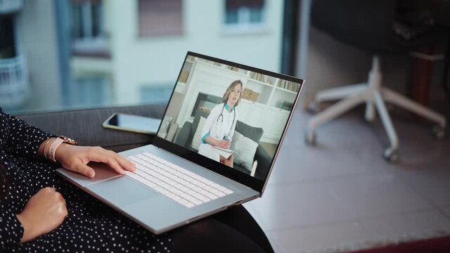 Remote medical care. Computer screen with young woman doctor consulting patient online