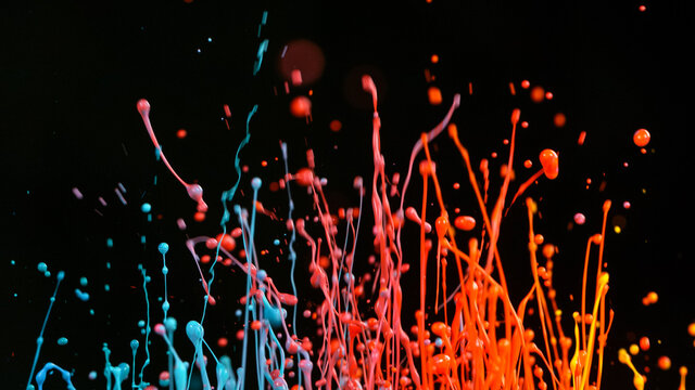 Freeze motion shot of color liquid explosion isolated on black background.